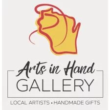 Arts in Hand Gallery logo featuring a stylized Wisconsin outline, promoting local artists and handmade gifts in Spooner, Wisconsin.